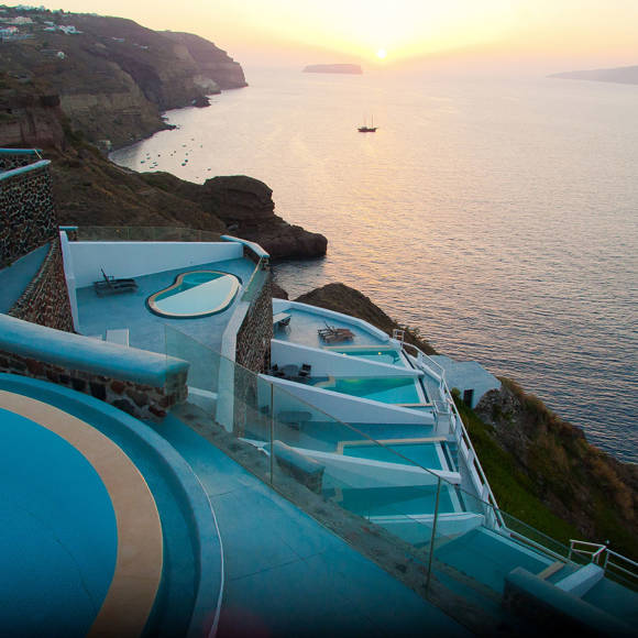 Cliffside pools and terraces at Grand Ambassador hotel overlooking the sea at sunset