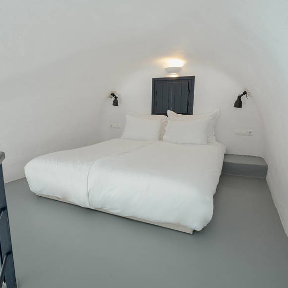 Grand Ambassador Santorini Petit Suite bedroom with vaulted ceiling and double bed in Cycladic style