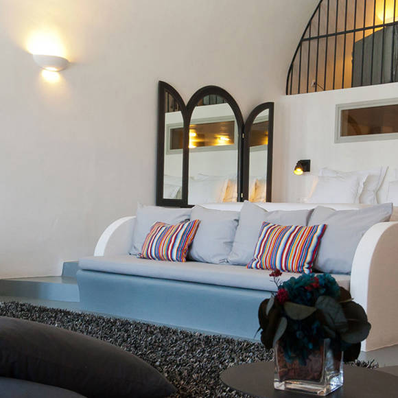 Grand Ambassador Santorini Infinity Honeymoon Cave Suite stylish vaulted bedroom and living area