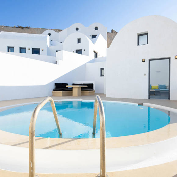 Grand Ambassador Santorini Serenity Two Bedroom Suite private pool terrace with Cycladic architecture and outdoor seating area