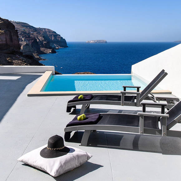 Grand Ambassador Santorini Infinity Cave Suite outdoor pool area with sun loungers and panoramic sea views