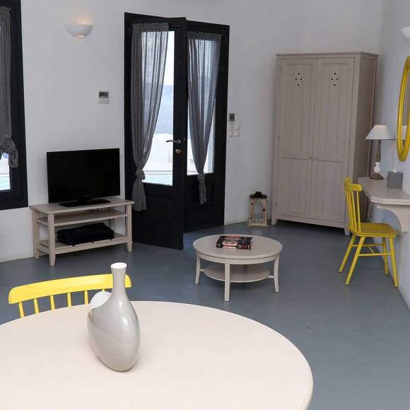 Grand Ambassador Santorini Luxury Suite open-plan room with lounge, desk, and natural light