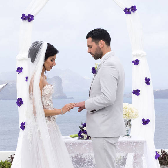 Grand Ambassador wedding venue outdoor ceremony with bride and groom exchanging rings by the sea