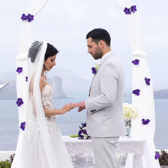 Grand Ambassador wedding venue outdoor ceremony with bride and groom exchanging rings by the sea