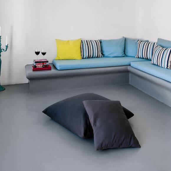 Grand Ambassador Santorini Luxury Suite stylish living area with built-in seating and modern decor