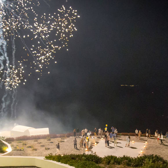 Grand Ambassador wedding venue night celebration with fireworks above guests and sea view