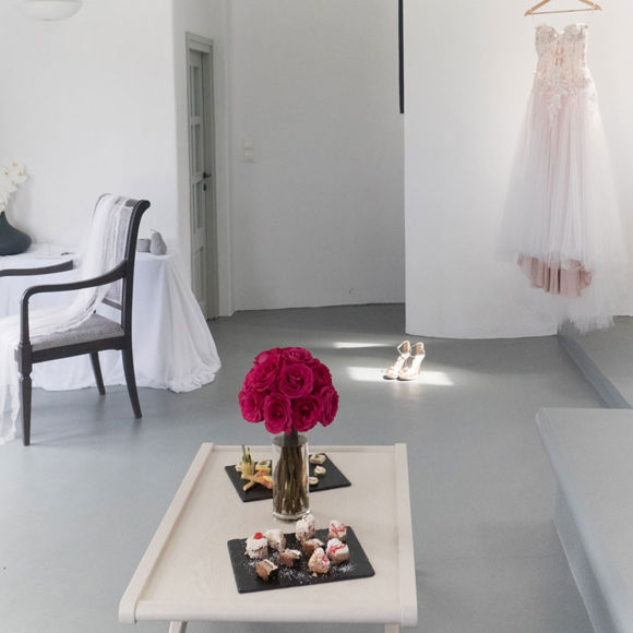 Grand Ambassador wedding suite with bridal gown, rose bouquet, and desserts on table